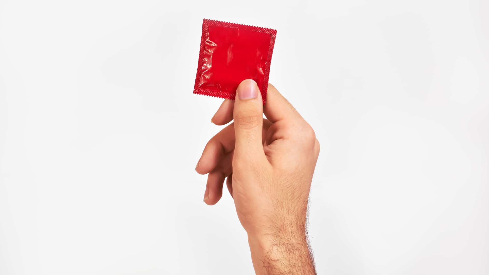 Man Holding Condom Wrapper